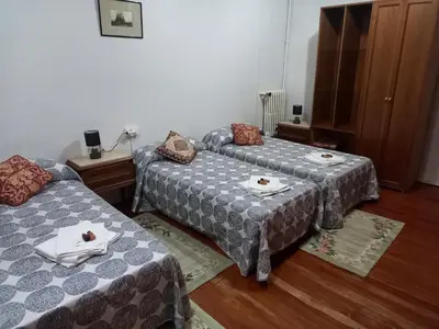 two beds in a room with plates of food on them at EL BORDON DE LA CASA BATALLON in Sarria