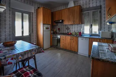 a kitchen with wooden cabinets and a counter top at CASA DIEGO in Monforte de Lemos