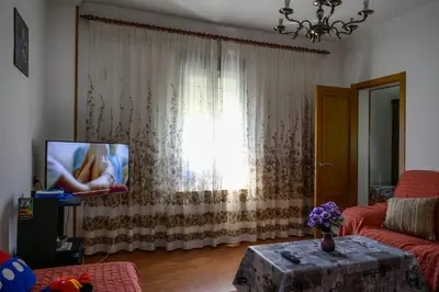 a living room with a couch and a tv at CASA DIEGO in Monforte de Lemos