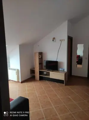 a living room with a flat screen tv on a table at Atico Cuntis Thermae in Cuntis