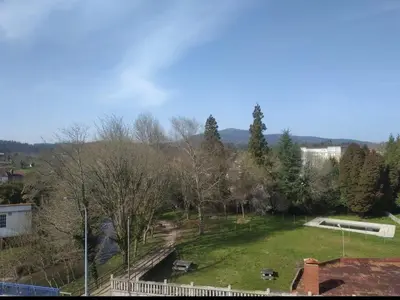 a large green park with trees and a building at Atico Cuntis Thermae in Cuntis