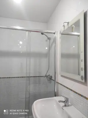 a bathroom with a shower and a sink at Atico Cuntis Thermae in Cuntis