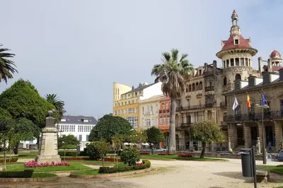 a large building with a fountain in front of it at Ribadeo Cantábrico Yporá Deptos in Ribadeo