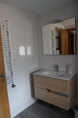 a bathroom with a sink and a mirror at Apartamento CATA Santiago de Compostela in Santiago de Compostela