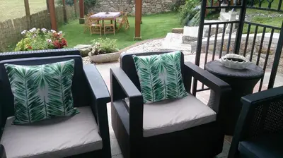 two chairs with pillows sitting on a patio at Casa De Cacheiro in Silleda