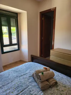 a bedroom with a bed with towels on it at Alojamiento Pena da Osa in Sober
