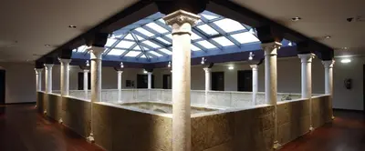 a large room with columns and a glass ceiling at Hotel Palacio de Merás in Tineo