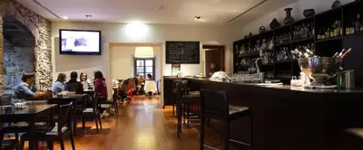 a bar in a restaurant with people sitting at tables at Hotel Palacio de Merás in Tineo