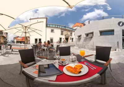a table with a plate of food on a patio at Hotel Palacio de Merás in Tineo