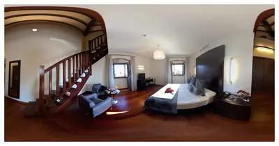 a living room with a bed and a staircase at Hotel Palacio de Merás in Tineo
