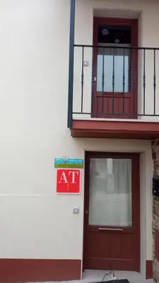 an ak sign on the side of a building with a door at Apartamentos Fons sacrata in Fonsagrada