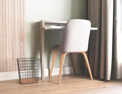 a white chair sitting next to a desk at IMI Hotel & Spa in Ourense