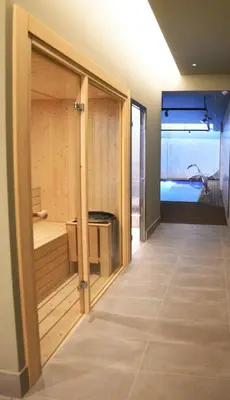 a room with a large glass door leading to a tub at IMI Hotel & Spa in Ourense