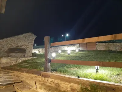 a field with lights in the grass at night at As Veneiras Casa in Neipín