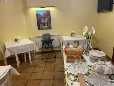 a room with two tables with plates and dishes at The Way Hotel Molinaseca in Molinaseca