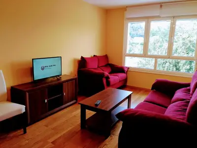 a living room with two couches and a tv at HOLIDAY HOMES by del abuelo VEGADEO in Vegadeo