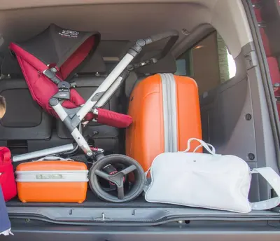 a trunk of a van filled with luggage and a stroller at HOLIDAY HOMES by del abuelo VEGADEO in Vegadeo