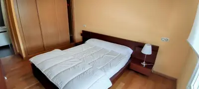 a small bedroom with a bed with white sheets at HOLIDAY HOMES by del abuelo VEGADEO in Vegadeo