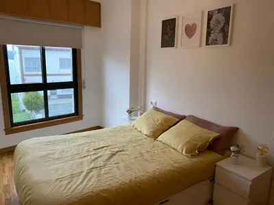 a bedroom with a large bed with a window at Luky Miño in Miño