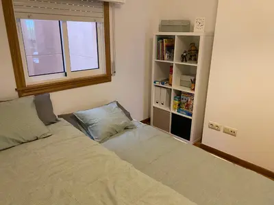 a bedroom with a bed and a book shelf at Luky Miño in Miño