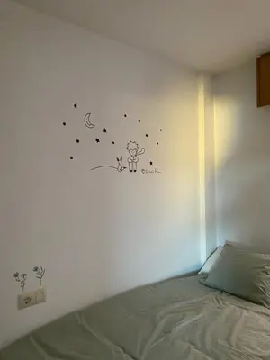 a bedroom with a bed with a sticker on the wall at Luky Miño in Miño