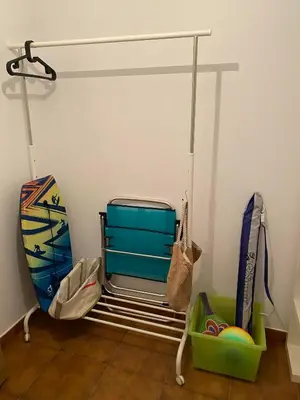 a room with a rack with a suitcase and other items at Luky Miño in Miño