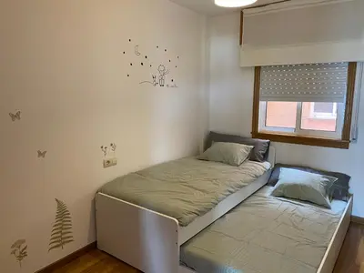 a bed in a room with a window at Luky Miño in Miño