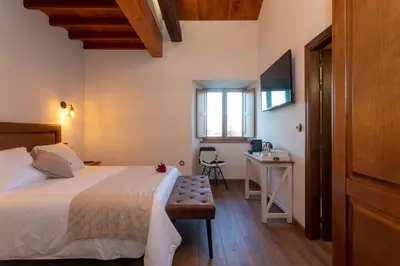 a bedroom with a bed and a table and a desk at Araucaria House in Barreiros