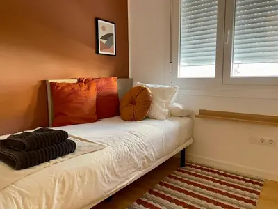 a bedroom with a bed with a basketball on it at Home Las Burgas D&C in Ourense