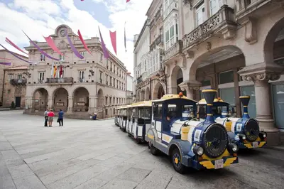 a train is parked in front of a building at Home Las Burgas D&C in Ourense