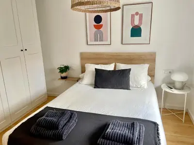 a bedroom with a bed with two pillows on it at Home Las Burgas D&C in Ourense
