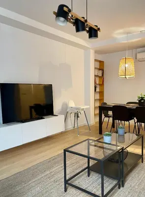 a living room with a large tv and a table at Home Las Burgas D&C in Ourense