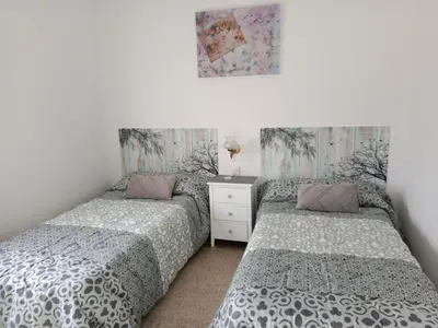 a bedroom with two beds and a dresser at CAMBOTE Vivienda turìstica in Lugo