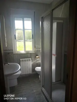 a bathroom with a toilet and a sink and a shower at CAMBOTE Vivienda turìstica in Lugo