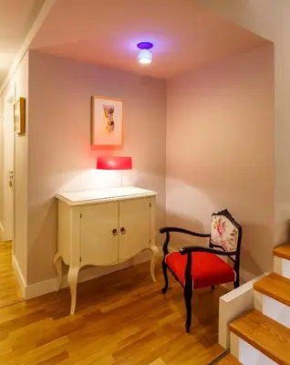 a room with a table and a chair and a lamp at Hotel Casa da Galbana in Friol