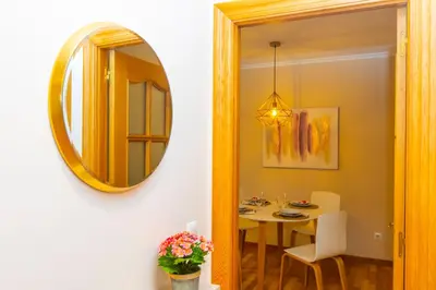a dining room with a table and a mirror at APARTAMENTO RIAMAR - A ESTRENAR in Ribadeo