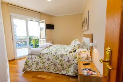 a small bedroom with a bed and a window at APARTAMENTO RIAMAR - A ESTRENAR in Ribadeo