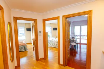 a room with two doors leading to a bedroom at APARTAMENTO RIAMAR - A ESTRENAR in Ribadeo
