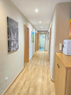 a hallway of a room with wood floors and a hallway at Pensión Pedrouzo in O Pedrouzo