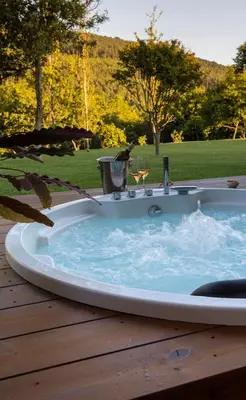 a jacuzzi tub sitting on a wooden deck at Hotel La Rectoral in Covelo