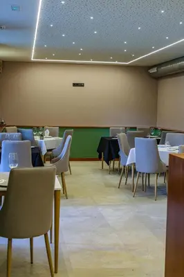 a dining room with tables and chairs in a room at Hotel La Rectoral in Covelo