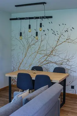 a dining room with a table with chairs and birds on the wall at Hotel La Rectoral in Covelo