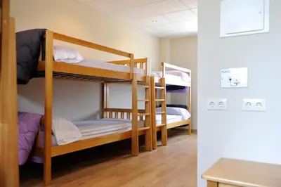 a room with three bunk beds in a room at Albergue El Aleman in Boente