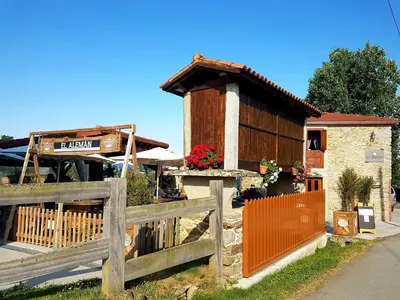 a wooden fence in front of a building at Albergue El Aleman in Boente