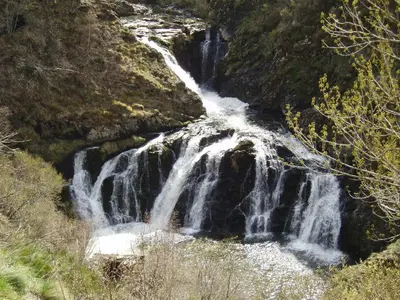 a waterfall on the side of a mountain at Casa Rural El Llao Y Los Fresnos in Murias de Paredes