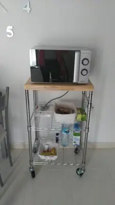 a kitchen cart with a microwave on top of it at Alborada in Viveiro