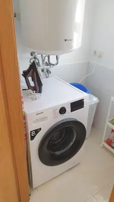 a white washing machine sitting in a room at Alborada in Viveiro