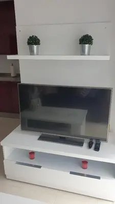 a flat screen tv sitting on a white entertainment center at Alborada in Viveiro