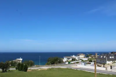a view of the ocean from a house at Apartamentos Los Gemelos in Foz