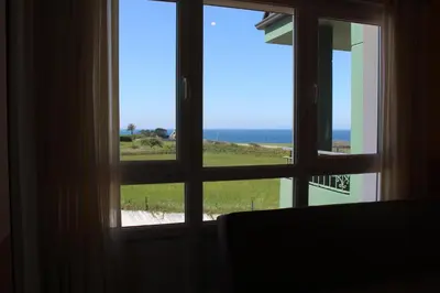 a view of the ocean from a window at Apartamentos Los Gemelos in Foz